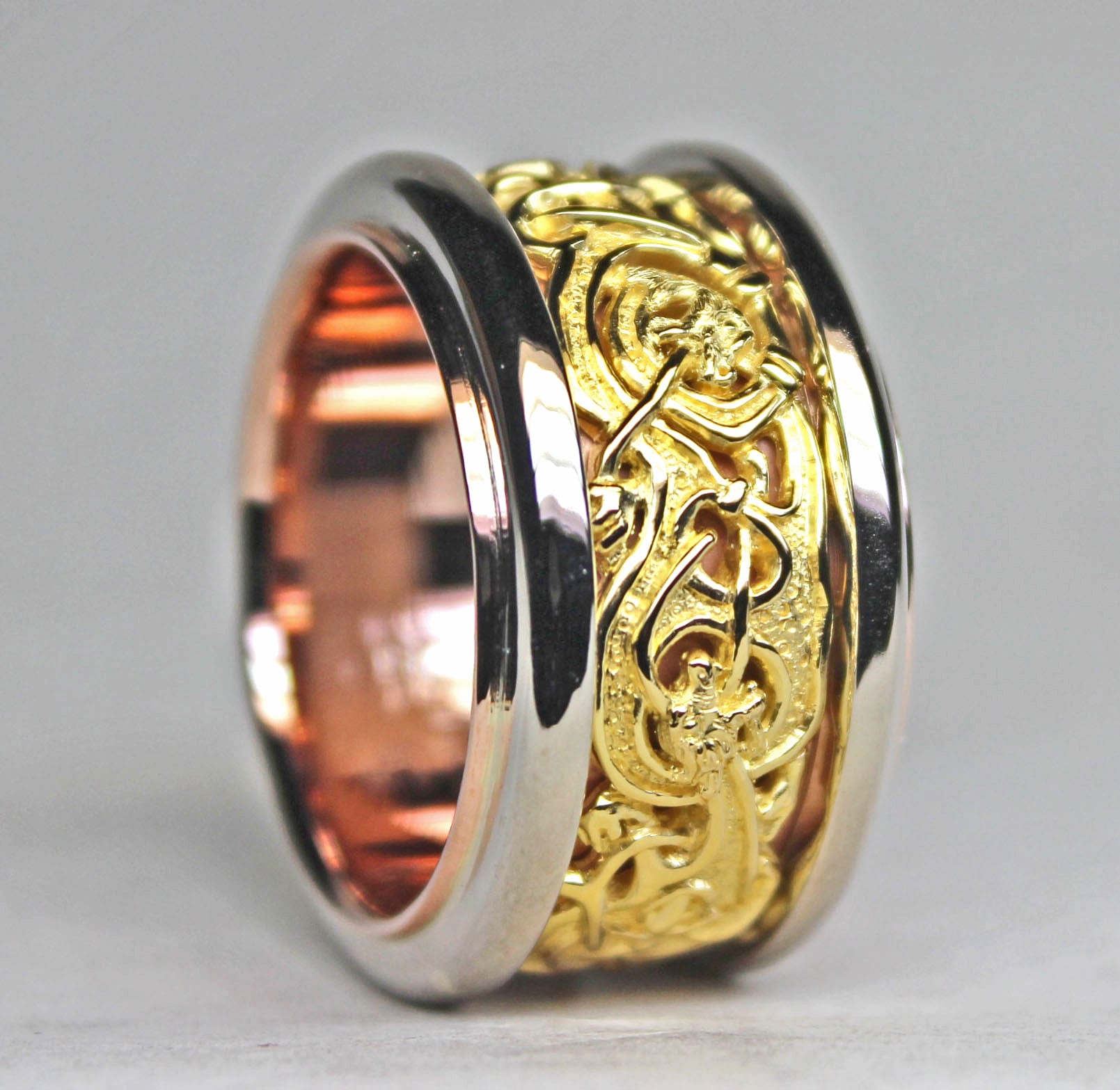 Custom Viking Gripping Beast ring in 14K rose, 14K white, and 22K yellow gold by George Postgate