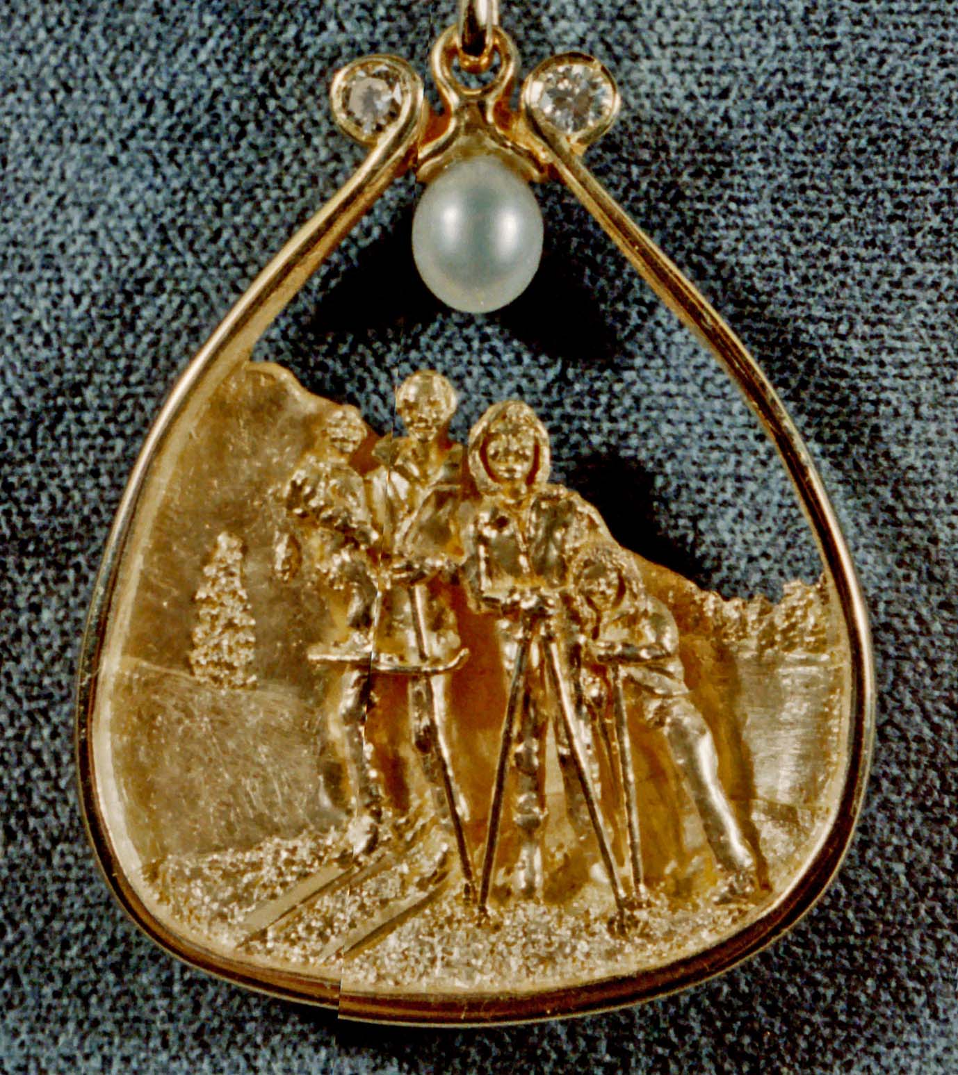 A family's ski weekend. In 18K with pearl and diamonds by George Postgate