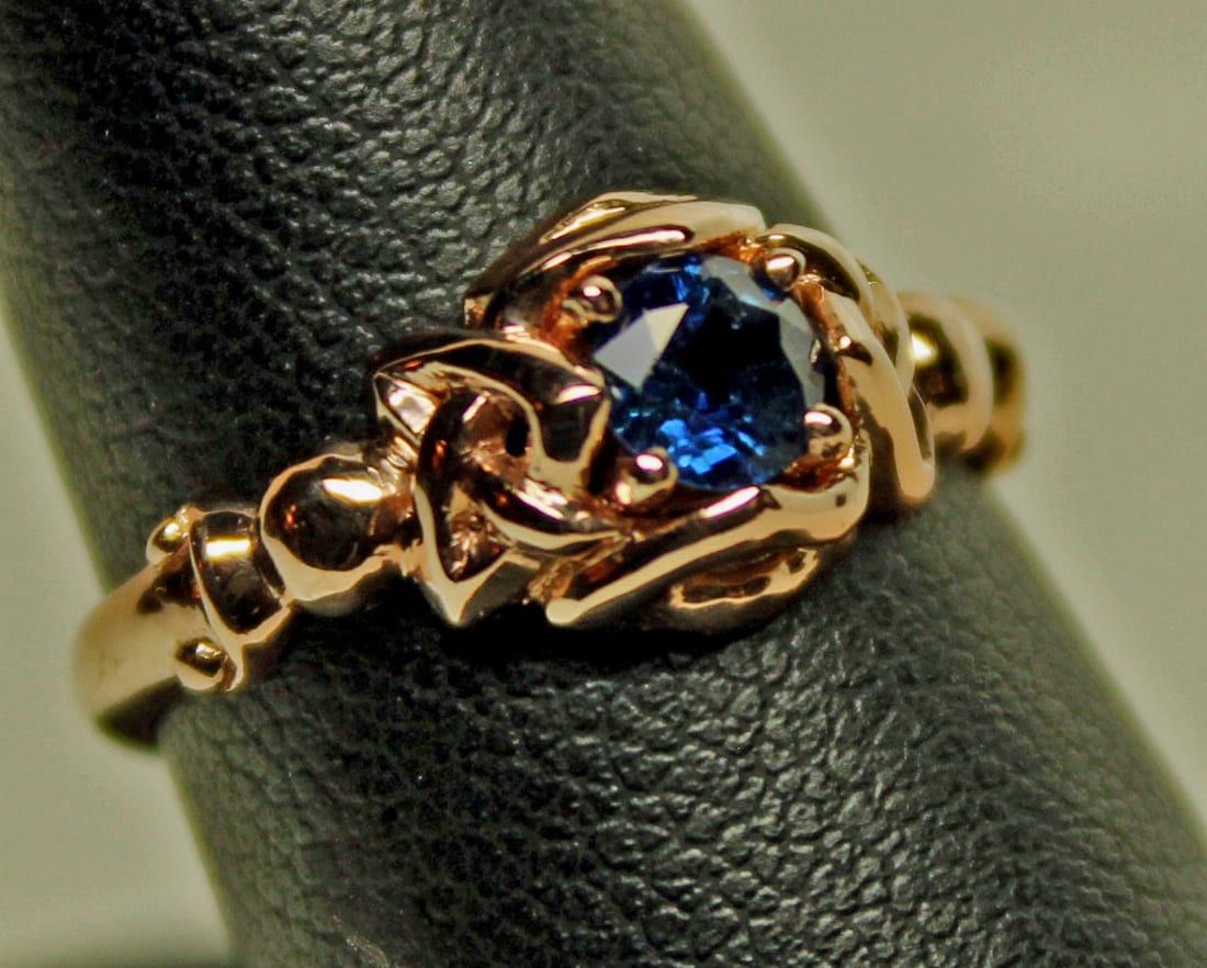 Celtic simple one stone knot ring with natural sapphire in 14K rose gold, by George Postgate