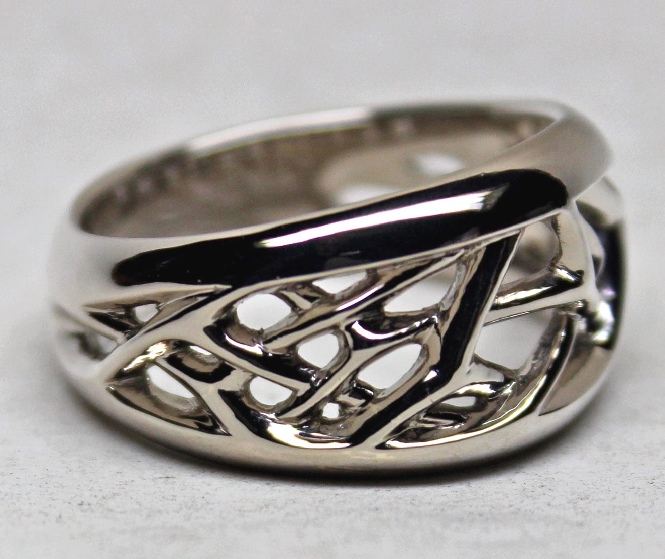 Open frost crystal band design in 14K palladium white gold. by George Postgate