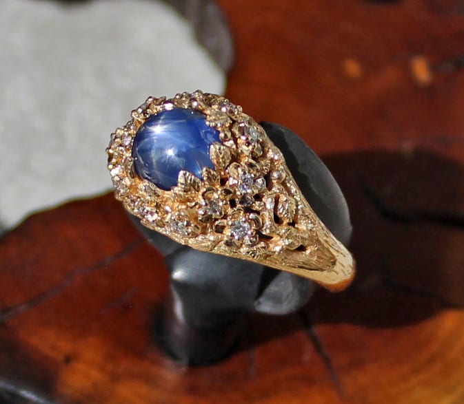 Flower ring with natural star sapphire and diamonds by George Postgate