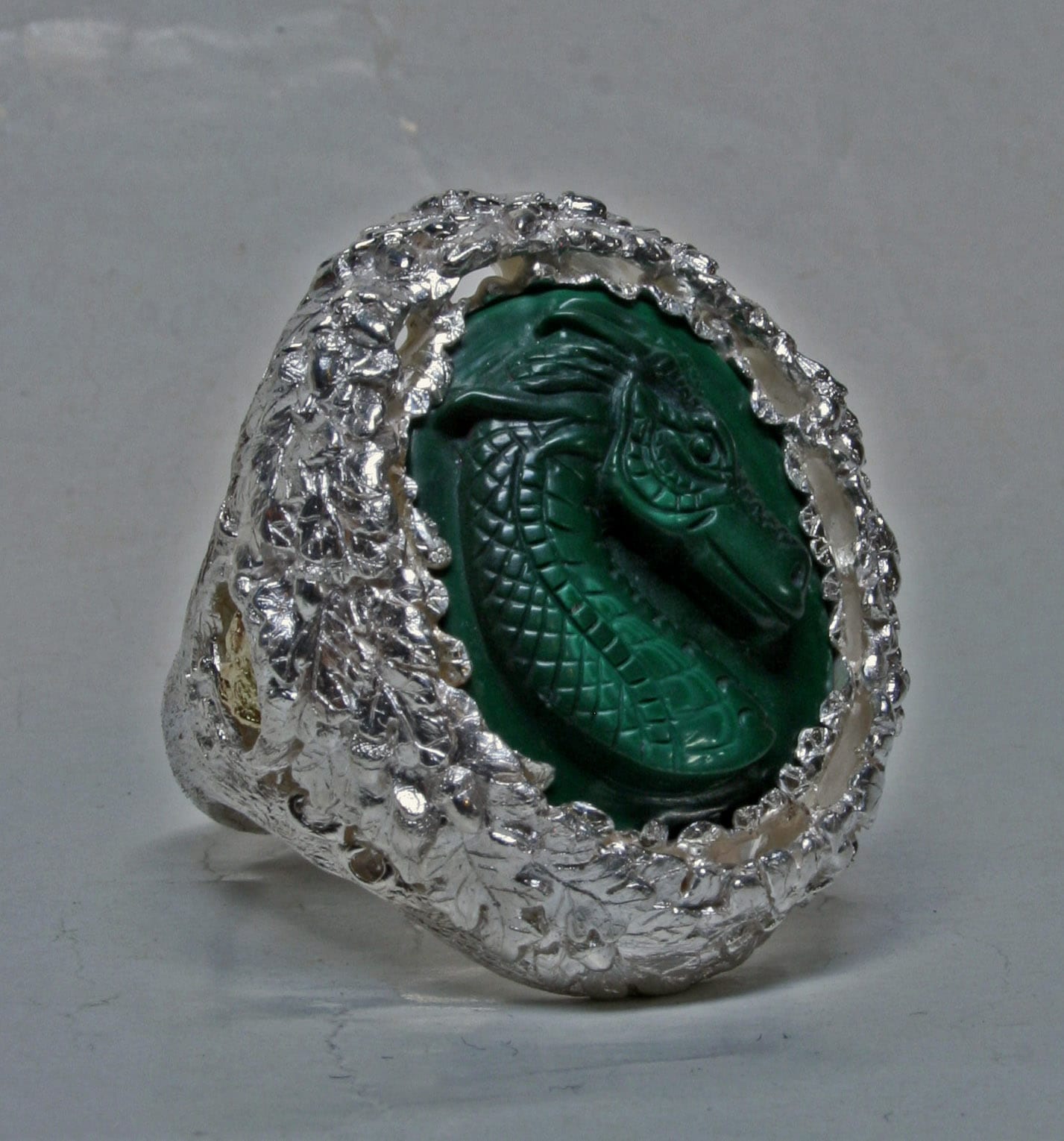 Dragon cameo carved in malachite in an Oak leaf sterling silver setting by George Postgate