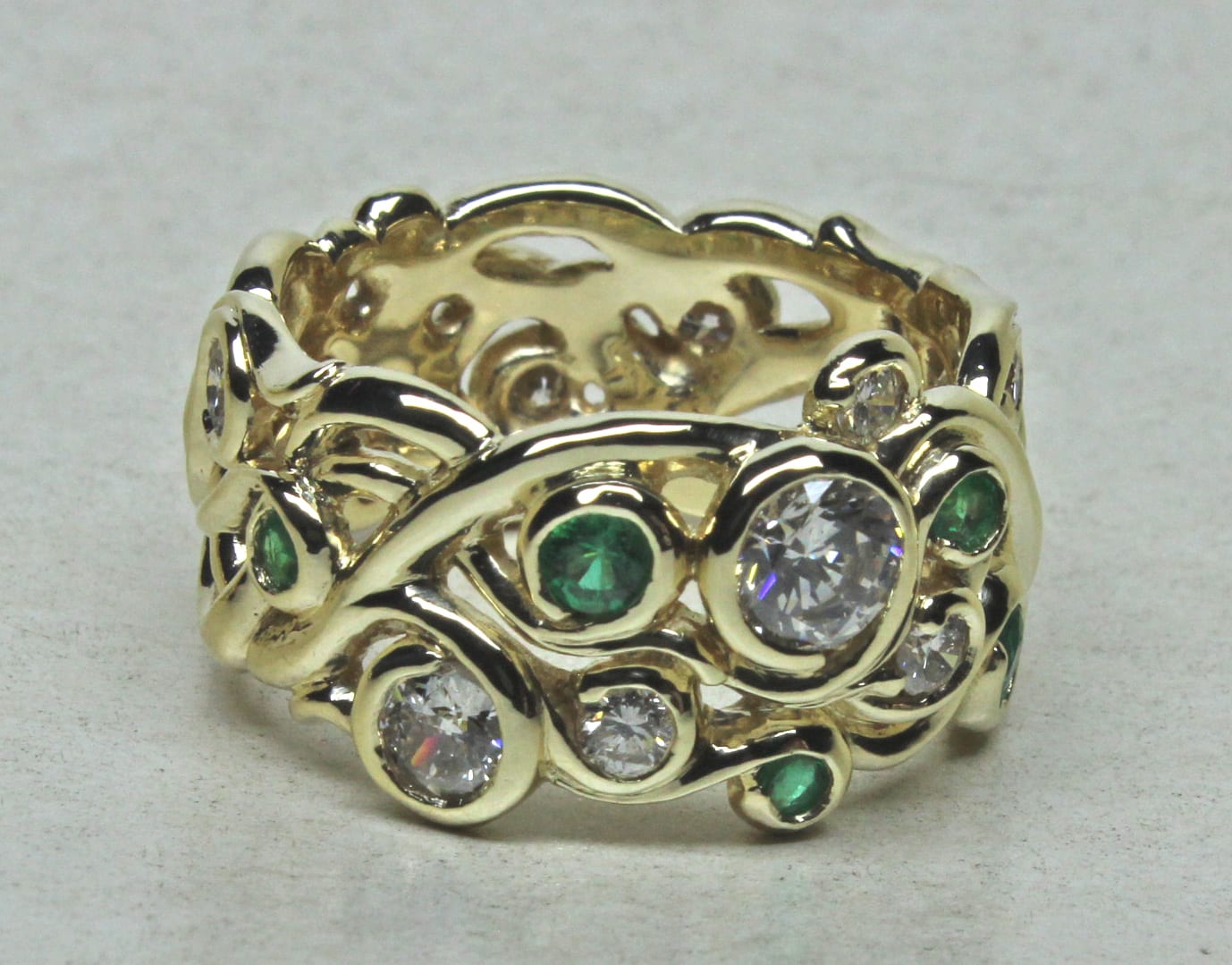 Custom swirling mists of Avalon 18K band with emeralds and diamonds, by George Postgate