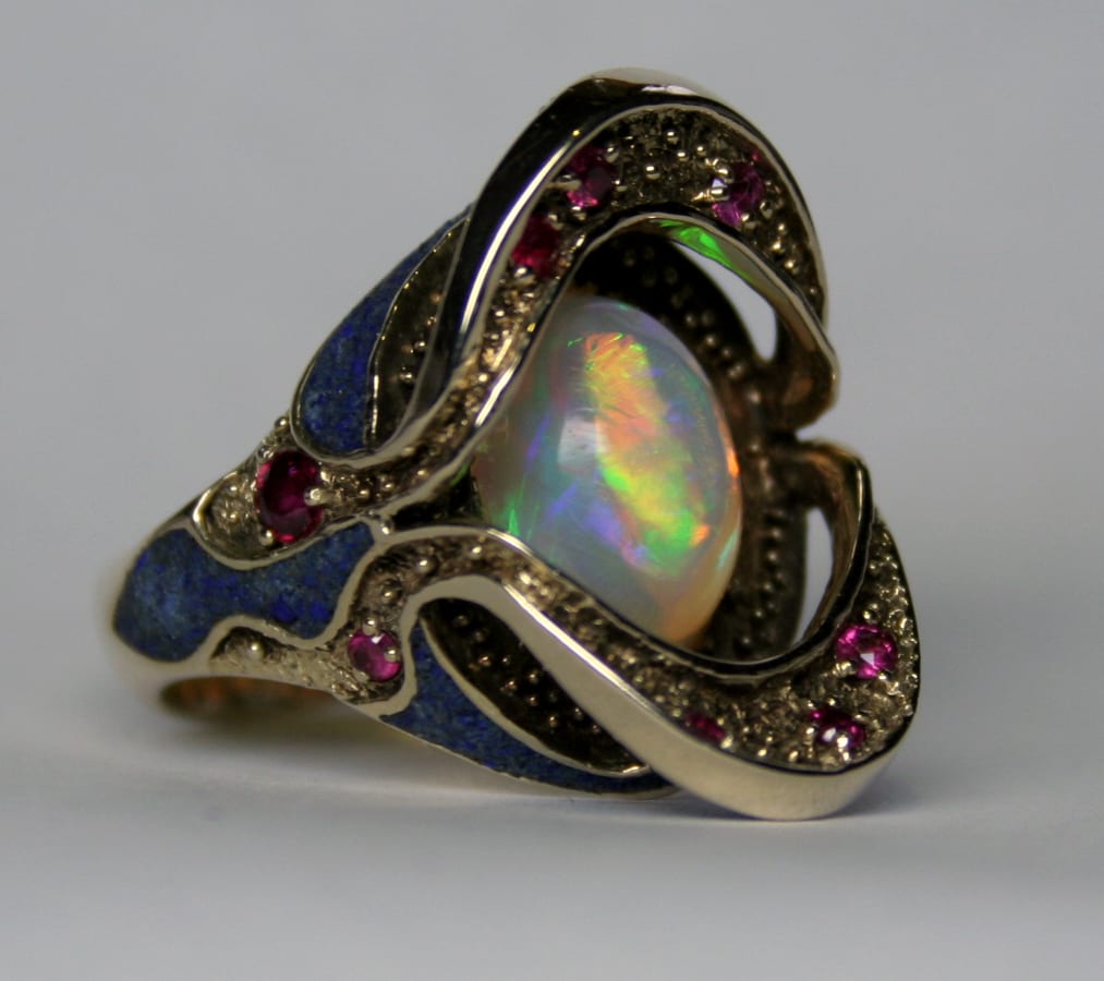 Art Nouveau granulated, lapis, Australian semi black opal, (with a rolling flash) and ruby ring in 14K by George Postgate
