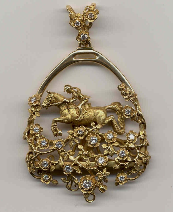 Horse and rider in a stirrup shaped pendant in 18K and diamonds by George Postgate