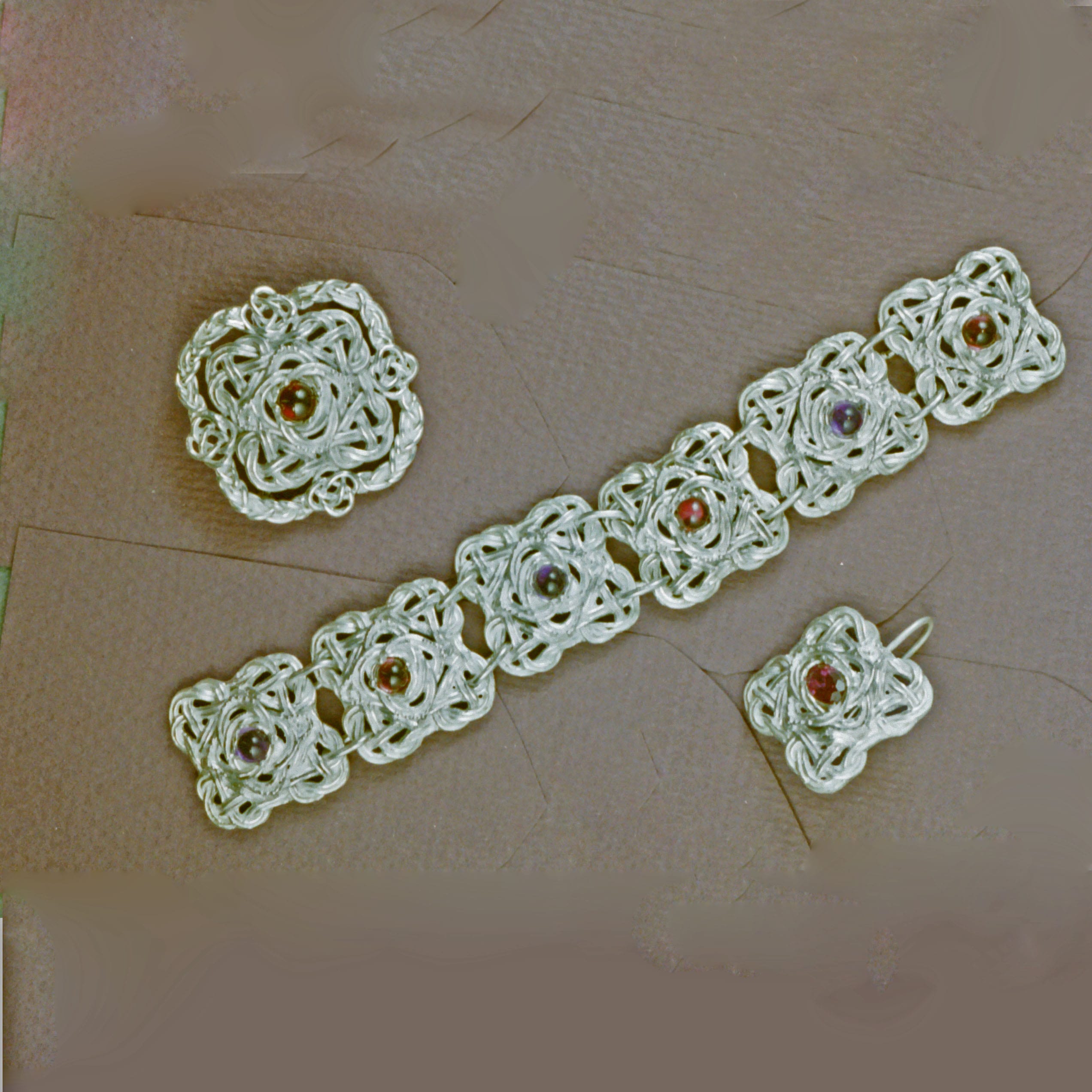 Open Celtic knot bracelet with sapphires and rubies by Suzan Postgate