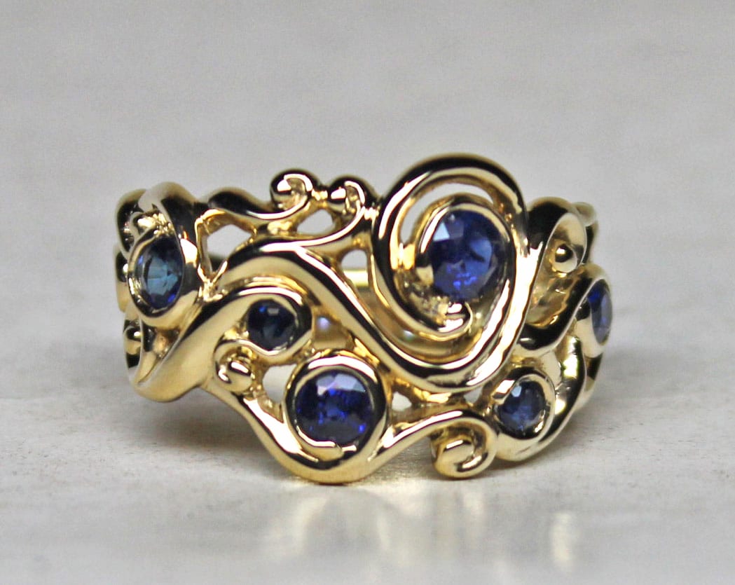 Swirling mists with ring shank band in 18K set with natural sapphires by George Postgate