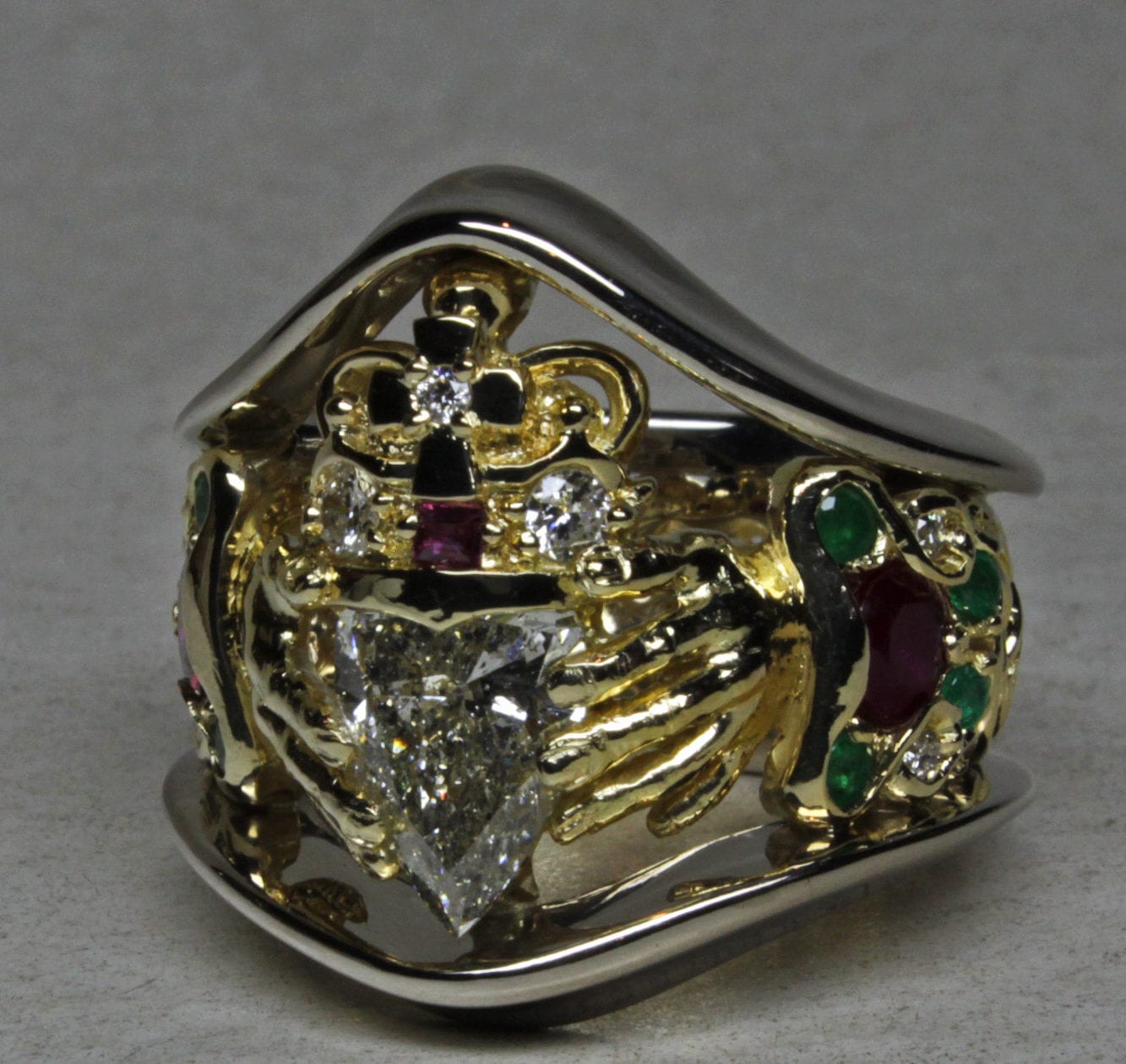 Irish Claddagh ring with diamond, ruby, and emerald in white and yellow gold