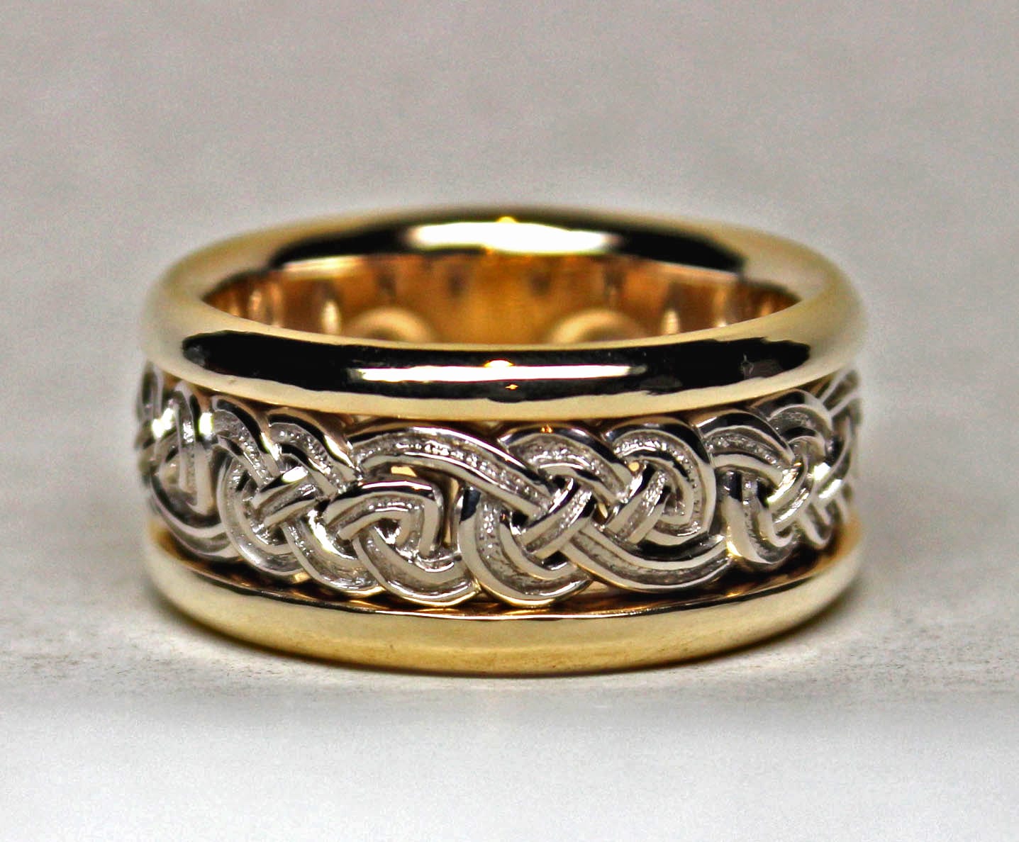 Celtic eternity knot band in 18K yellow and 14K white gold by George Postgate