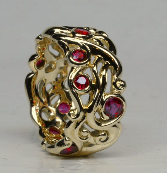 Large swirling mists of Avalon band in 18K set with fine rubies by George Postgate