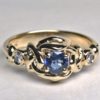 Simple Celtic heart knot ring with 3mm sapphire and two 2mm diamonds. By George