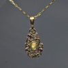 Curvilinear Pendant with sapphire ruby and opal in 14K by Suzan