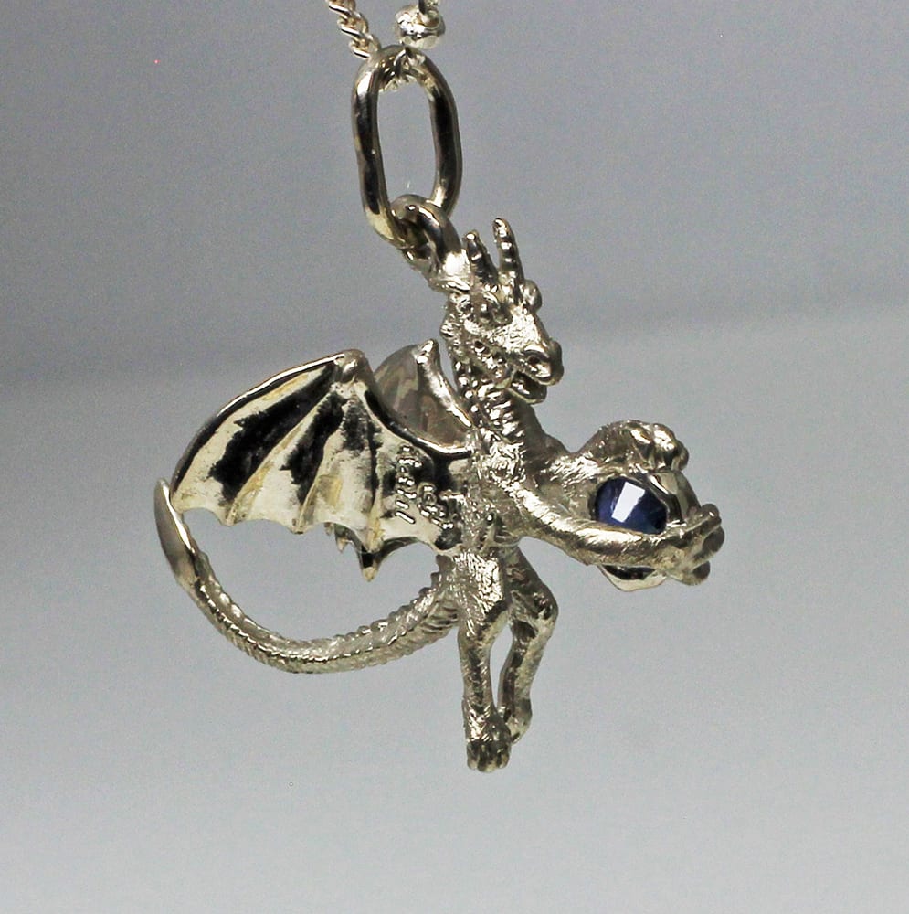 Sapphire dragon pendant, by George Postgate. In white gold.