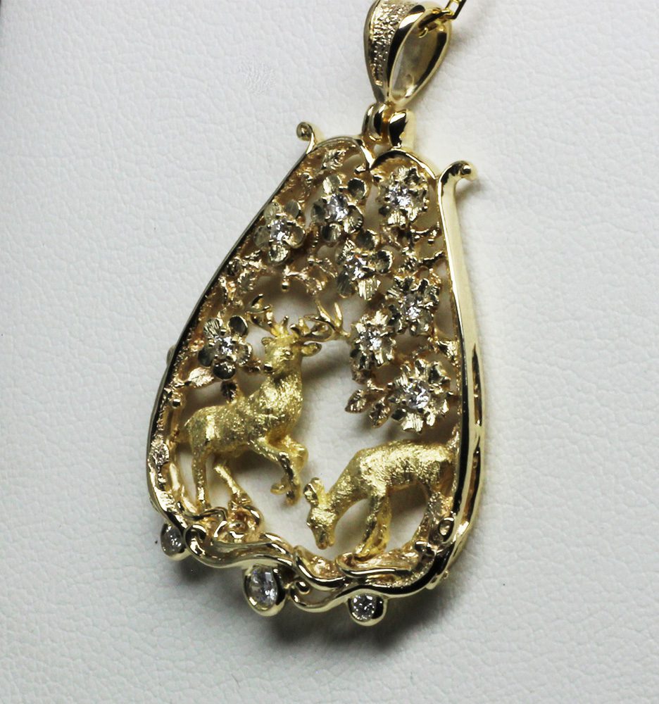 Highland deer gold pendant, deer in a woodland of gold.