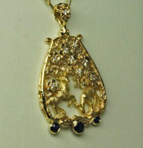 Highland Deer gold Pendant in 14K and 18K yellow gold with  fine diamonds and sapphires