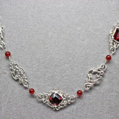 Lacy Silver Garnet Necklace, I've been watching Suzan work on this exceptional necklace for quite a while and it is finally finished. The necklace is made up of lacy sterling silver links and three beautiful faceted garnets.