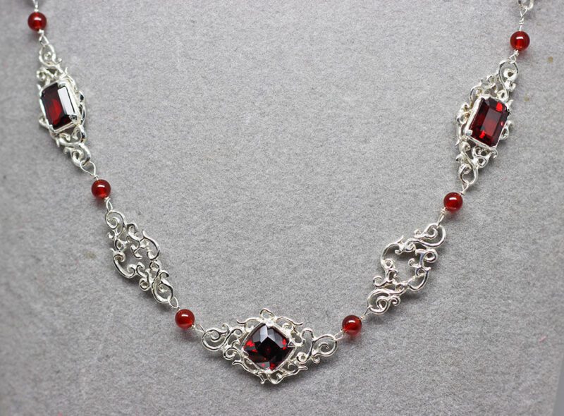 Lacy Silver Garnet Necklace, I've been watching Suzan work on this exceptional necklace for quite a while and it is finally finished. The necklace is made up of lacy sterling silver links and three beautiful faceted garnets.