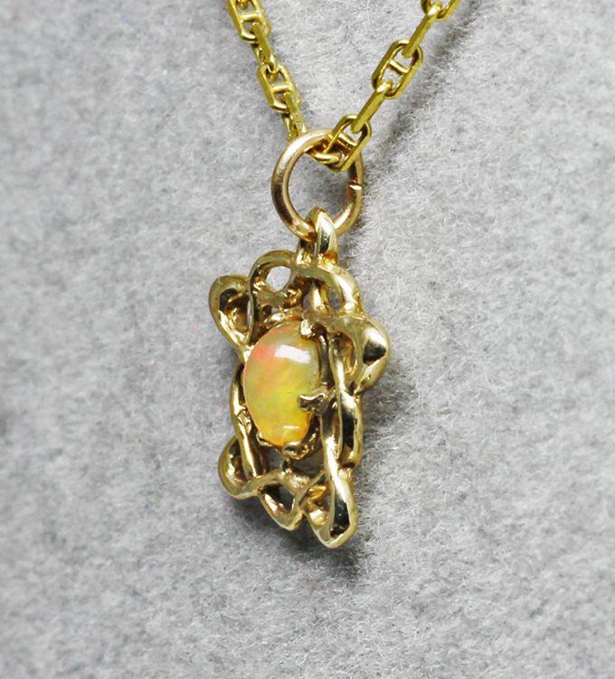 Petite Celtic opal pendant Details: The pendant was first built up and sculpted in wax by Suzan, it was then cast in 14K gold and finished. It is approximately 15 X 15mm in size not counting its bale. The opal is an Ethiopian stone that is approximately 6 X 5 mm.